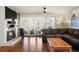 Comfortable living room featuring a brick fireplace, hardwood floors, and sliding glass doors at 7192 S Vine E Cir, Centennial, CO 80122