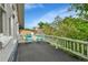 Inviting balcony with gray flooring, white railing, and two blue chairs offer outdoor enjoyment at 7011 Grandview Ave, Arvada, CO 80002