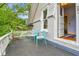 Charming balcony with gray flooring, white railing, and two blue chairs, perfect for outdoor relaxation at 7011 Grandview Ave, Arvada, CO 80002