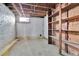 Exposed brick basement with visible wood beams and shelving at 7011 Grandview Ave, Arvada, CO 80002