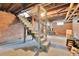 Unfinished basement with exposed brick, stairs, and concrete floor is ready to be finished at 7011 Grandview Ave, Arvada, CO 80002