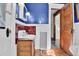 Cozy bathroom with vintage sink, red tile accents, and blue walls, featuring hardwood floors at 7011 Grandview Ave, Arvada, CO 80002