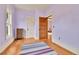 Cozy bedroom with pastel walls, wood floors, and an antique radiator at 7011 Grandview Ave, Arvada, CO 80002