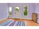 Sunny bedroom featuring multiple windows with green tree views and pastel colored walls at 7011 Grandview Ave, Arvada, CO 80002