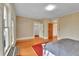 Spacious bedroom featuring hardwood floors, neutral wallpaper, and ample natural light at 7011 Grandview Ave, Arvada, CO 80002