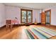 Bedroom with natural light, musical instruments, hardwood floors, and neutral color palette at 7011 Grandview Ave, Arvada, CO 80002