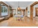 Spacious dining room with hardwood floors, period details, and views to other rooms at 7011 Grandview Ave, Arvada, CO 80002