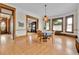 Elegant dining room with wood floors, detailed trim, and a view to the cozy fireplace at 7011 Grandview Ave, Arvada, CO 80002