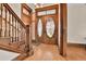 Elegant entryway features original wood details, a staircase, and unique oval-windowed doors at 7011 Grandview Ave, Arvada, CO 80002