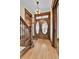 Elegant entryway boasts original wood trim, hardwood floors, and a grand staircase at 7011 Grandview Ave, Arvada, CO 80002
