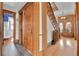 Hallway showcasing hardwood floors, wooden doors, staircase, and vintage details at 7011 Grandview Ave, Arvada, CO 80002