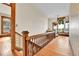 Second floor hallway featuring wooden railing and floors with natural lighting and a seating area at 7011 Grandview Ave, Arvada, CO 80002