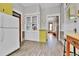 Bright, classic kitchen with white and yellow cabinets, featuring an antique-style glass-front cabinet at 7011 Grandview Ave, Arvada, CO 80002