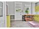 Bright kitchen with a rustic island, vintage cabinetry, and lots of natural light at 7011 Grandview Ave, Arvada, CO 80002