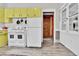 Functional kitchen showcasing colorful cabinetry, ample storage, and vintage appliances at 7011 Grandview Ave, Arvada, CO 80002