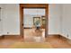 Spacious room with original wood trim, hardwood flooring, and views into the dining room at 7011 Grandview Ave, Arvada, CO 80002