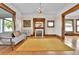 Inviting living room with a vintage fireplace, hardwood floors, and plenty of natural light at 7011 Grandview Ave, Arvada, CO 80002