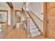 Bright interior showcasing a staircase with carpeted steps and original wooden trim at 7011 Grandview Ave, Arvada, CO 80002