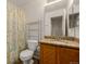 Bathroom featuring granite countertops, a mirrored cabinet, and a shower with patterned curtain at 11141 Gaylord St, Northglenn, CO 80233