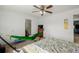 Carpeted bedroom featuring a hammock, ceiling fan, and ensuite bathroom at 11141 Gaylord St, Northglenn, CO 80233