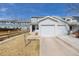 Charming two-story home featuring light blue siding and attached garage and manicured lawn at 11141 Gaylord St, Northglenn, CO 80233