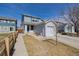 Charming two-story home featuring light blue siding and attached garage and manicured lawn at 11141 Gaylord St, Northglenn, CO 80233