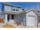 Charming two-story home featuring light blue siding and attached garage and manicured lawn at 11141 Gaylord St, Northglenn, CO 80233