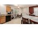 Cozy kitchen and breakfast nook with granite countertops, tile floors, and modern appliances at 11141 Gaylord St, Northglenn, CO 80233