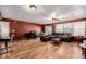 Spacious living room with a leather sofa, ceiling fan and wood flooring at 11141 Gaylord St, Northglenn, CO 80233