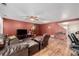 Spacious living room with a leather sofa, ceiling fan and wood flooring at 11141 Gaylord St, Northglenn, CO 80233