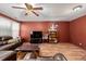 Spacious living room with a leather sofa, ceiling fan and wood flooring at 11141 Gaylord St, Northglenn, CO 80233