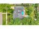 Aerial shot of the home and backyard featuring a patio, hot tub, mature landscaping, and open green space at 1935 Oneida St, Denver, CO 80220