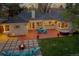 Aerial view of the backyard with patio furniture, fire pit, a hot tub, and a well-maintained lawn at 1935 Oneida St, Denver, CO 80220