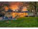 Large back yard with a brick patio, fire pit and lawn area at 1935 Oneida St, Denver, CO 80220