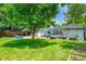Spacious backyard featuring a well-manicured lawn, patio, and hot tub at 1935 Oneida St, Denver, CO 80220