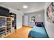 Bright bedroom features hardwood floors, storage shelves, a small window and closet space at 1935 Oneida St, Denver, CO 80220