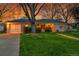 Charming single-story home with lush green lawn, walkway and driveway with detached garage at 1935 Oneida St, Denver, CO 80220