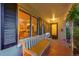 A covered porch features a bench and view into the front living room through large windows at 1935 Oneida St, Denver, CO 80220