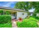 Close-up of the home's entrance and charming front yard, complete with garden and vibrant flowers at 1935 Oneida St, Denver, CO 80220