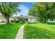Charming home with a lush, green lawn and a inviting walkway, enhanced by mature trees and manicured landscaping at 1935 Oneida St, Denver, CO 80220