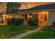 Charming home with a well-manicured lawn, walkway, and covered front porch at 1935 Oneida St, Denver, CO 80220