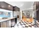 Bright eat-in kitchen with granite countertops and stainless steel appliances open to light-filled dining room at 1935 Oneida St, Denver, CO 80220