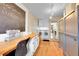Spacious laundry room with wood floors, bright light, sewing desk, and storage cabinets at 1935 Oneida St, Denver, CO 80220