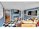 Bright living room with fireplace, black and white floors, a pass-through, and modern decor at 1935 Oneida St, Denver, CO 80220