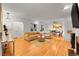 Bright living room with hardwood floors, neutral furniture, and view into the dining area at 1935 Oneida St, Denver, CO 80220