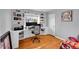 Bright home office features built-in shelving and drawers with hardwood floors, natural light at 1935 Oneida St, Denver, CO 80220
