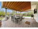 Covered patio with dining and seating areas, plus a green backyard at 6769 E Costilla Cir, Centennial, CO 80112