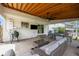 Backyard covered patio with outdoor seating, grill and adjacent lawn at 6769 E Costilla Cir, Centennial, CO 80112