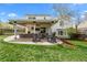 Spacious brick patio featuring an outdoor seating arrangement surrounded by green grass at 6769 E Costilla Cir, Centennial, CO 80112