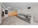 Finished basement with a large sofa, built-in shelves, and neutral carpeting at 6769 E Costilla Cir, Centennial, CO 80112